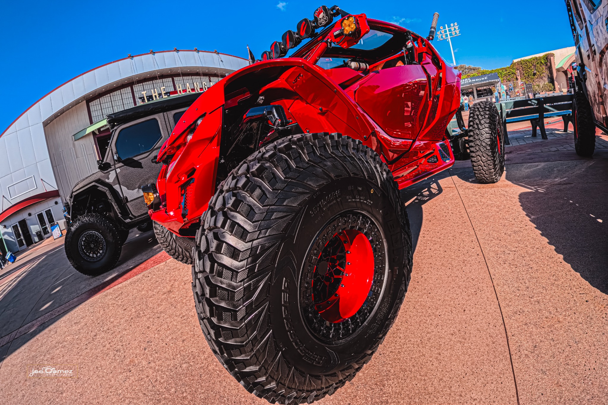 Front-quarter view of a red off-road vehicle outside the Hangar
