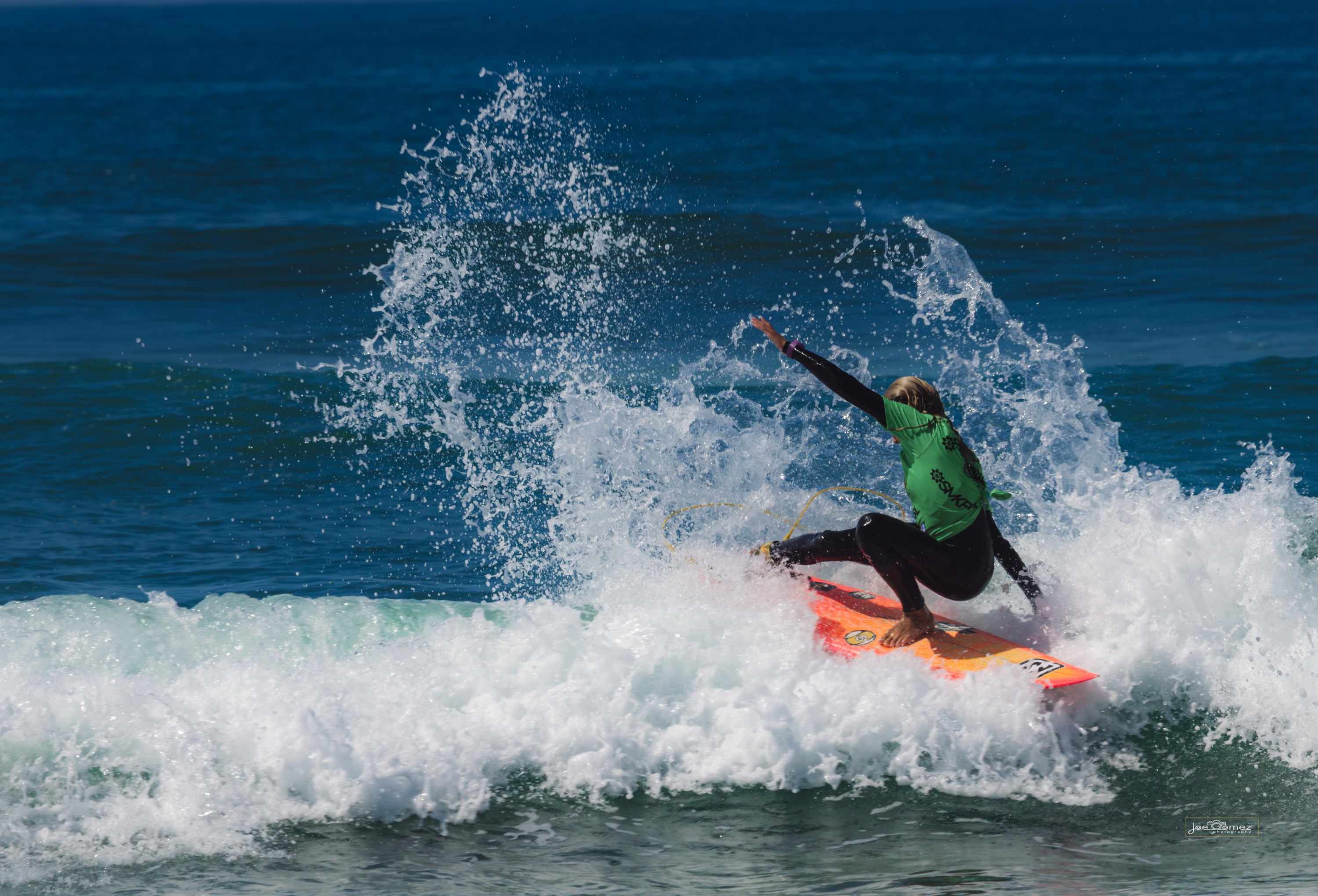 Young surfer carving through whitewater in the Super Girl Surf Festival editorial